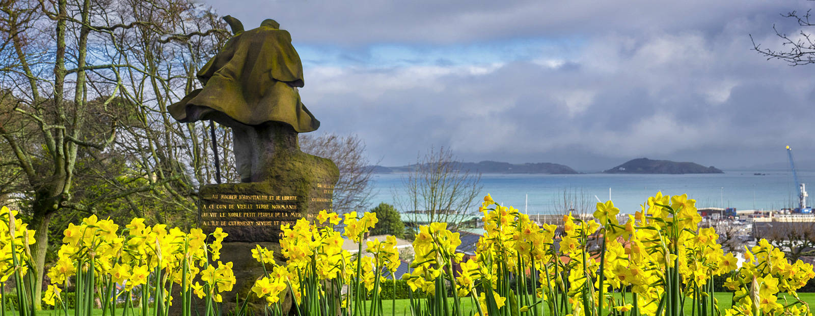 Victor Hugo statue amongst spring daffodils